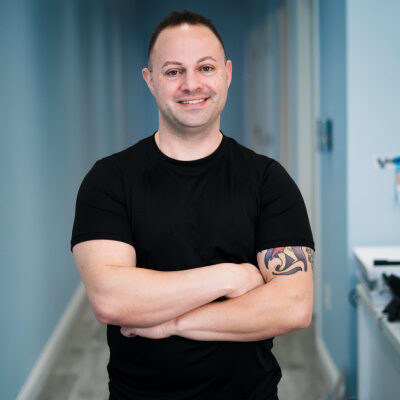 A smiling man in black clothes