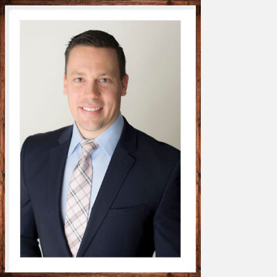 A framed photo of a man in a suit jacket and a necktie