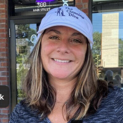 A smiling woman in a white cap